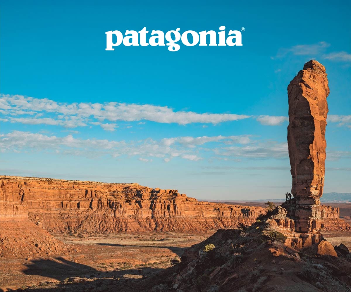  Two climbers approach a steep rock face in Bears Ears National Monument, Uta