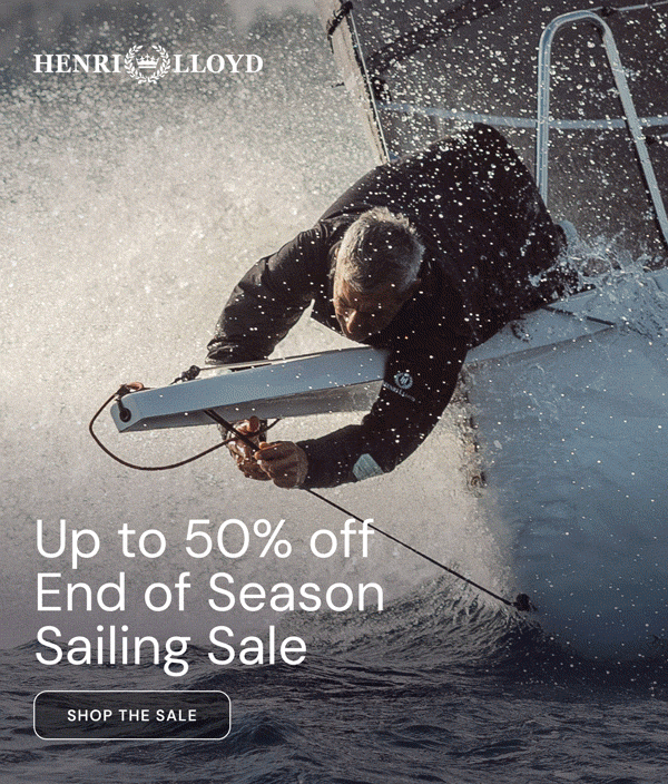 Sailor in a dark Henri Lloyd jacket on deck at sunset. Up to 50% off, End of Season Sailing Sale. Shop the sale