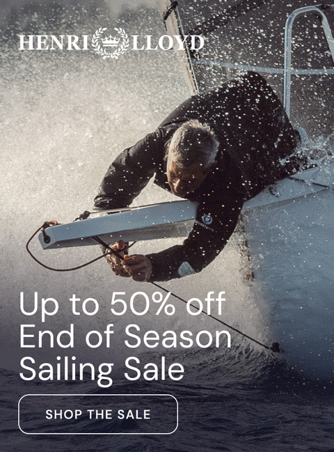Sailor in a dark Henri Lloyd jacket on deck at sunset. Up to 50% off, End of Season Sailing Sale. Shop the sale
