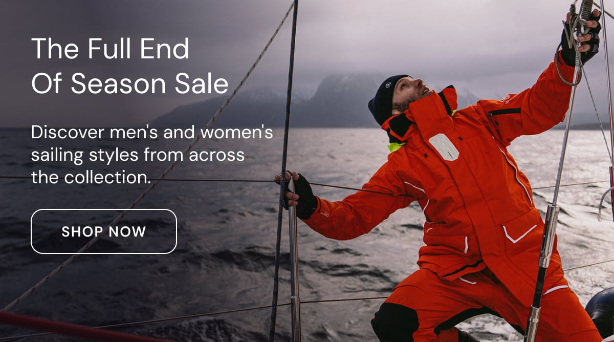 Sailor in an orange Henri Lloyd Elite Offshore jacket working the rigging at sea. The Full End of Season Sale: discover men's and women's sailing styles from across the collection. Shop now