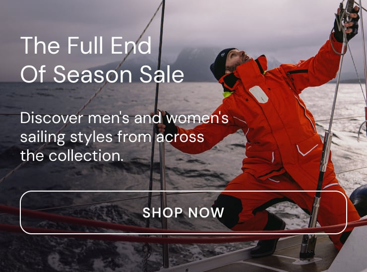 Sailor in an orange Henri Lloyd Elite Offshore jacket working the rigging at sea. The Full End of Season Sale: discover men's and women's sailing styles from across the collection. Shop now