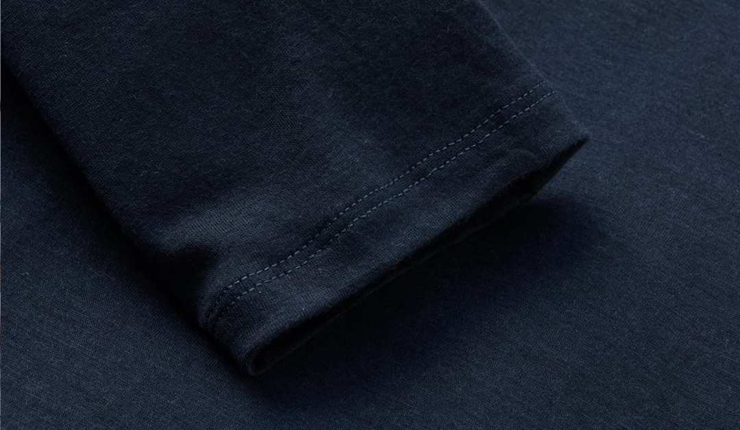 Close-up of navy blue fabric with stitching.