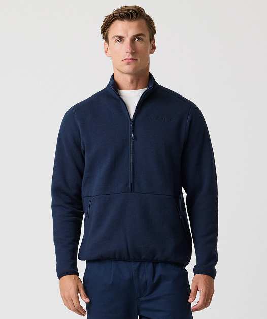 Man wearing navy fleece pullover with zipper.